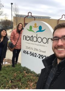 Nick, Amanda, and April standing in front of NextDoor Milwaukee sign