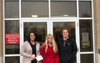 Devon, Alec, and Carly standing in front of the Milwaukee Rescue Mission building