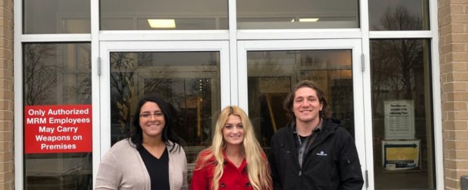 Devon, Alec, and Carly standing in front of the Milwaukee Rescue Mission building