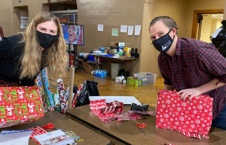 Brew City Marketing team members wrapping presents and volunteering time for the Milwaukee Rescue Mission