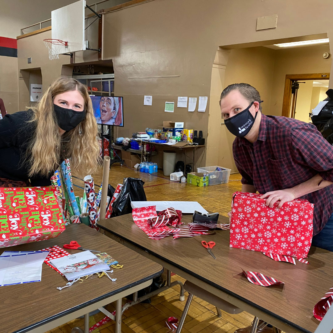 Brew City Marketing team members wrapping presents and volunteering time for the Milwaukee Rescue Mission