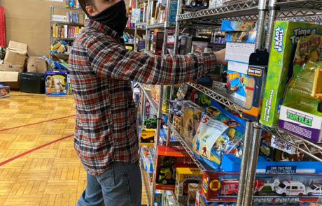 Brew City Marketing team member picking out gifts for children in need