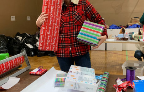 Amanda Dalnodar of Brew City Marketing wrapping presents for the Milwaukee Rescue Mission
