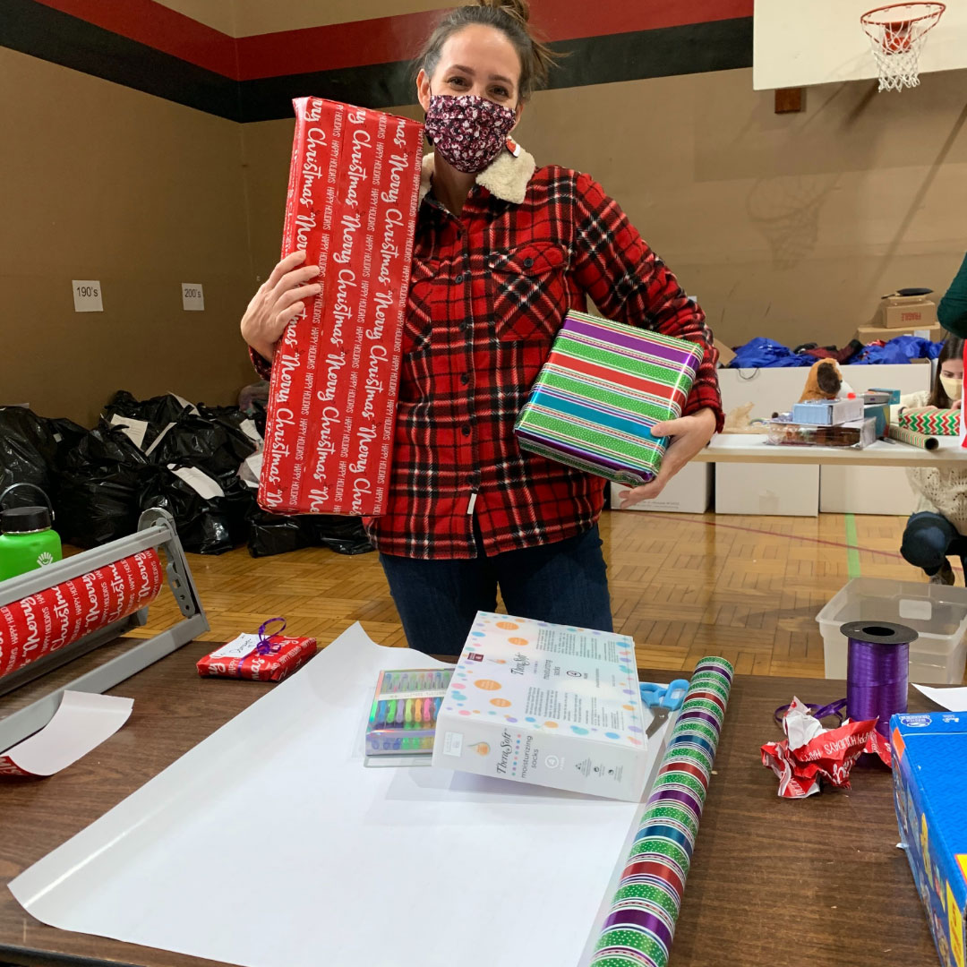 Amanda Dalnodar of Brew City Marketing wrapping presents for the Milwaukee Rescue Mission